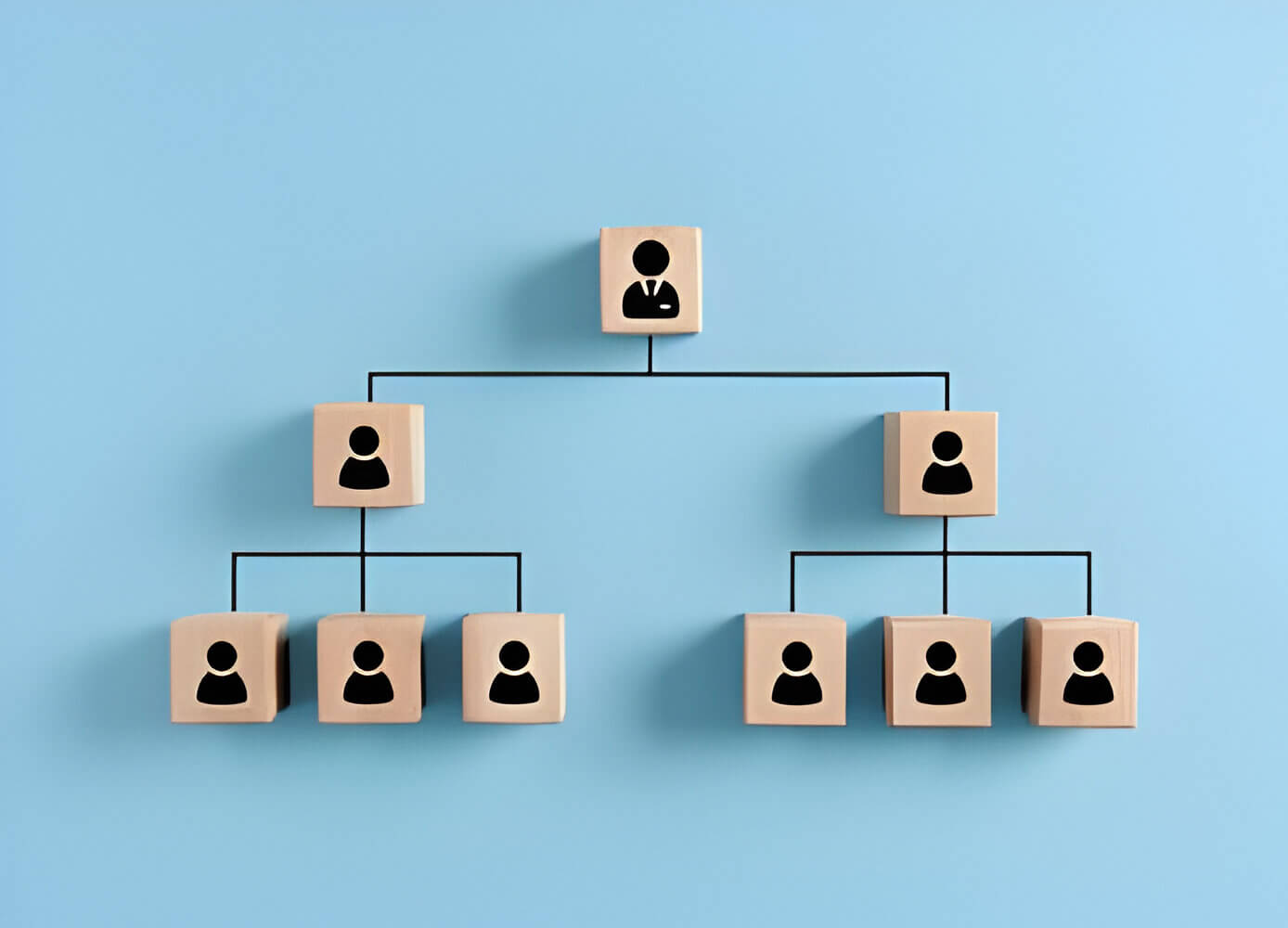 A pyramid of wooden blocks with people on them, symbolizing the hierarchical structure of user roles in Salesforce.